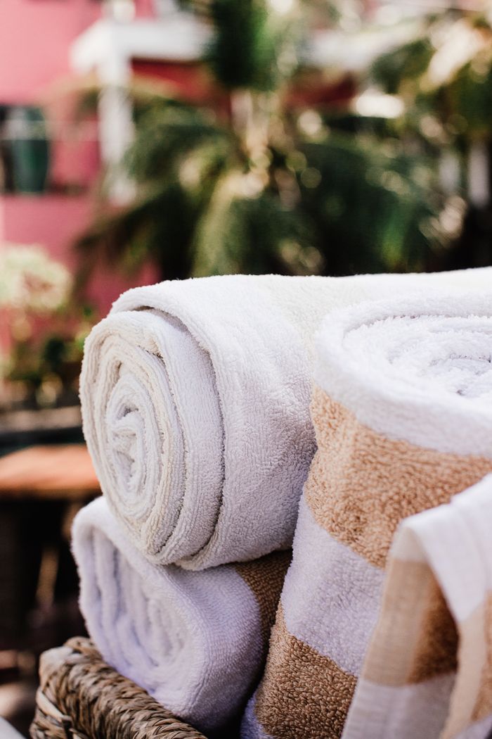 creative-03 High-quality cotton bath towels stacked outdoors, perfect for a relaxing spa day.